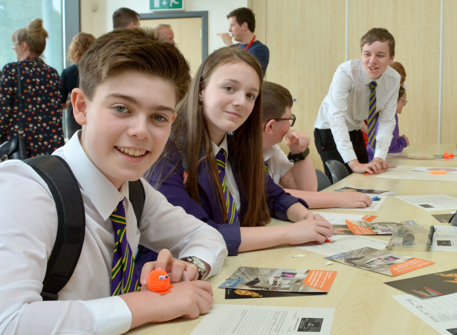 school pupils smiling at their desk