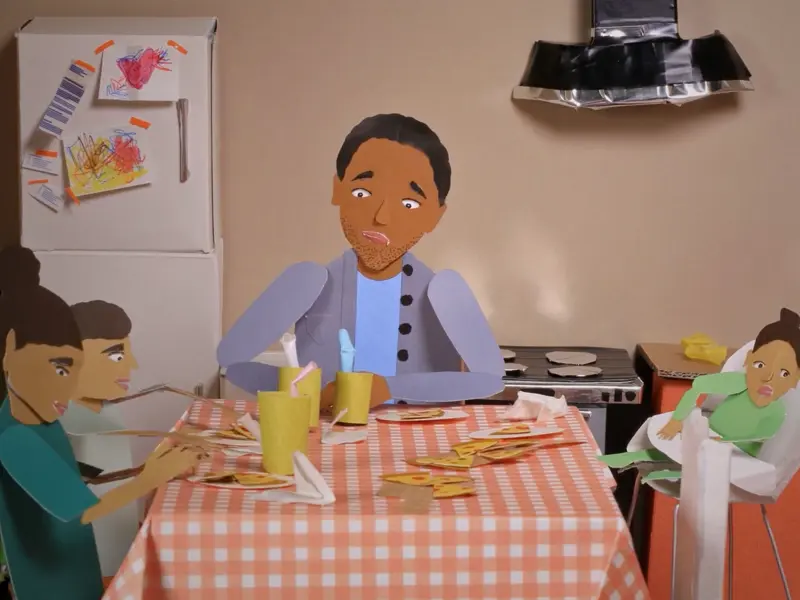 A papercrafted 3D scene of a dad and his three children sitting at the kitchen table.